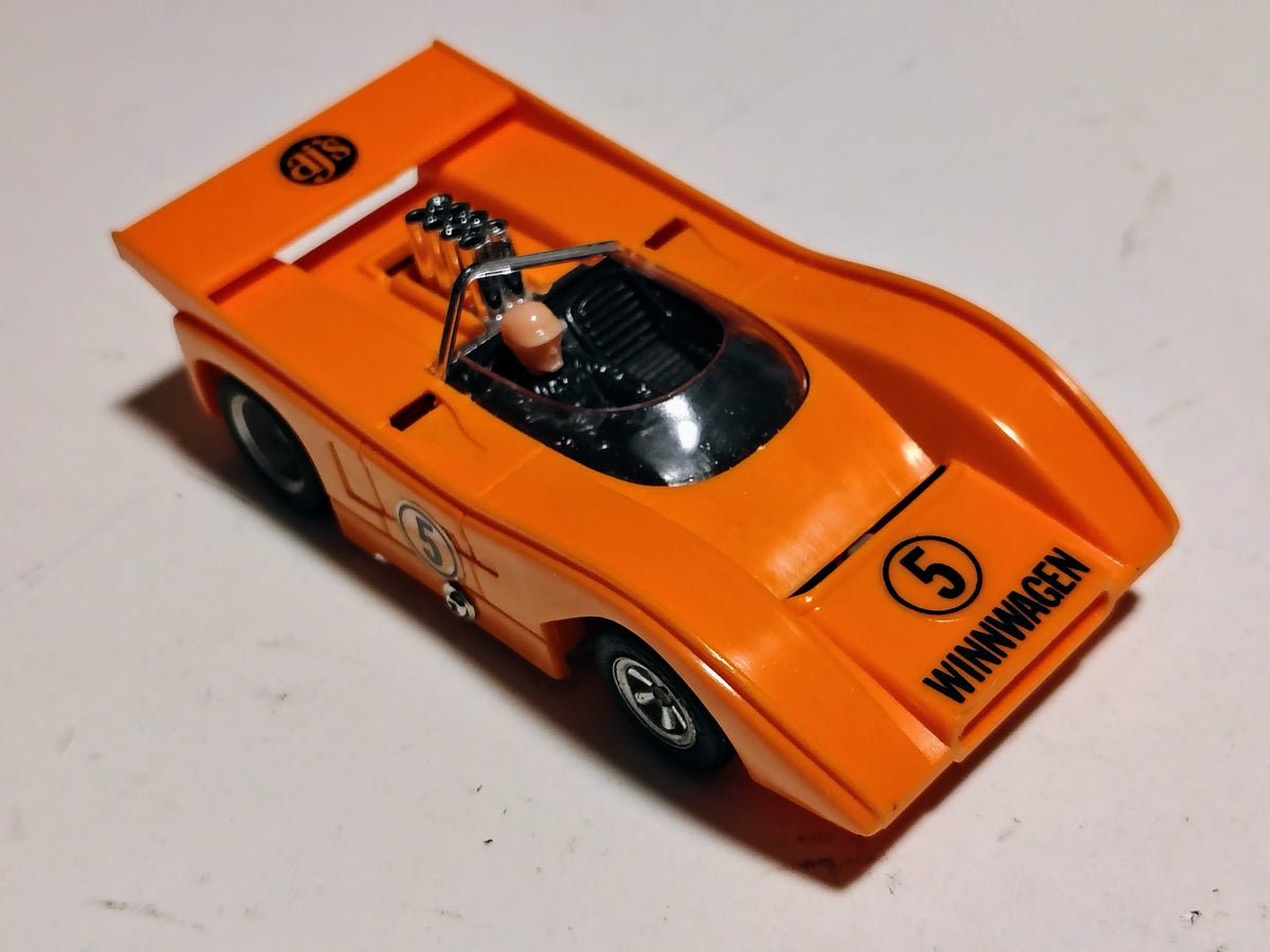 AJ's Winnwagen McLaren M8F orange number 5 vintage 1/32 slot car front three-quarter