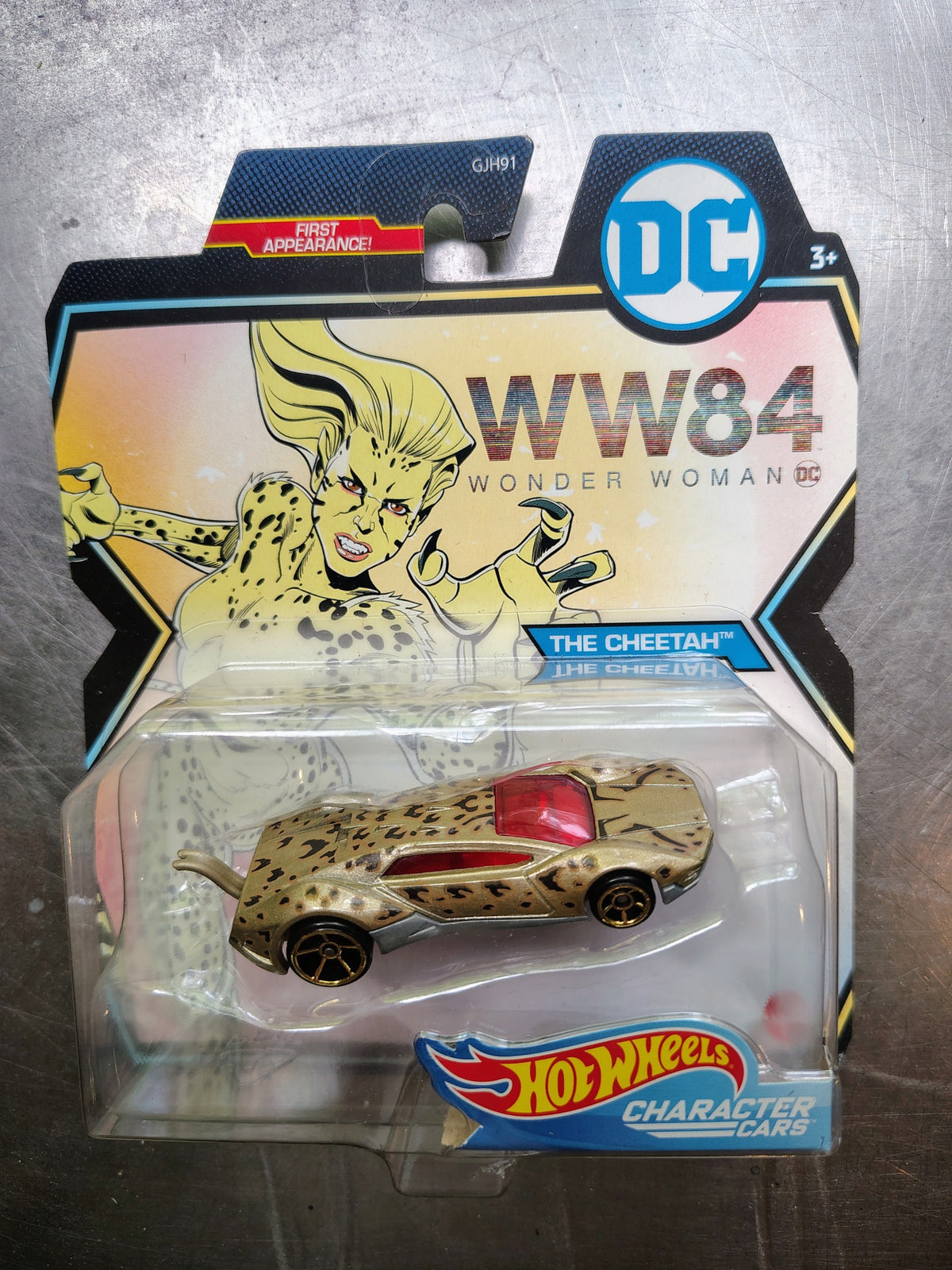 Actual included collectible 2: Hot Wheels DC Character Cars The Cheetah from Wonder Woman 1984, gold spotted body on illustrated DC card.