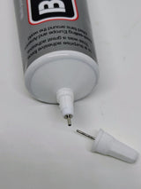 Close view of B-6000 fine metal glue nozzle and unclogging pin cap