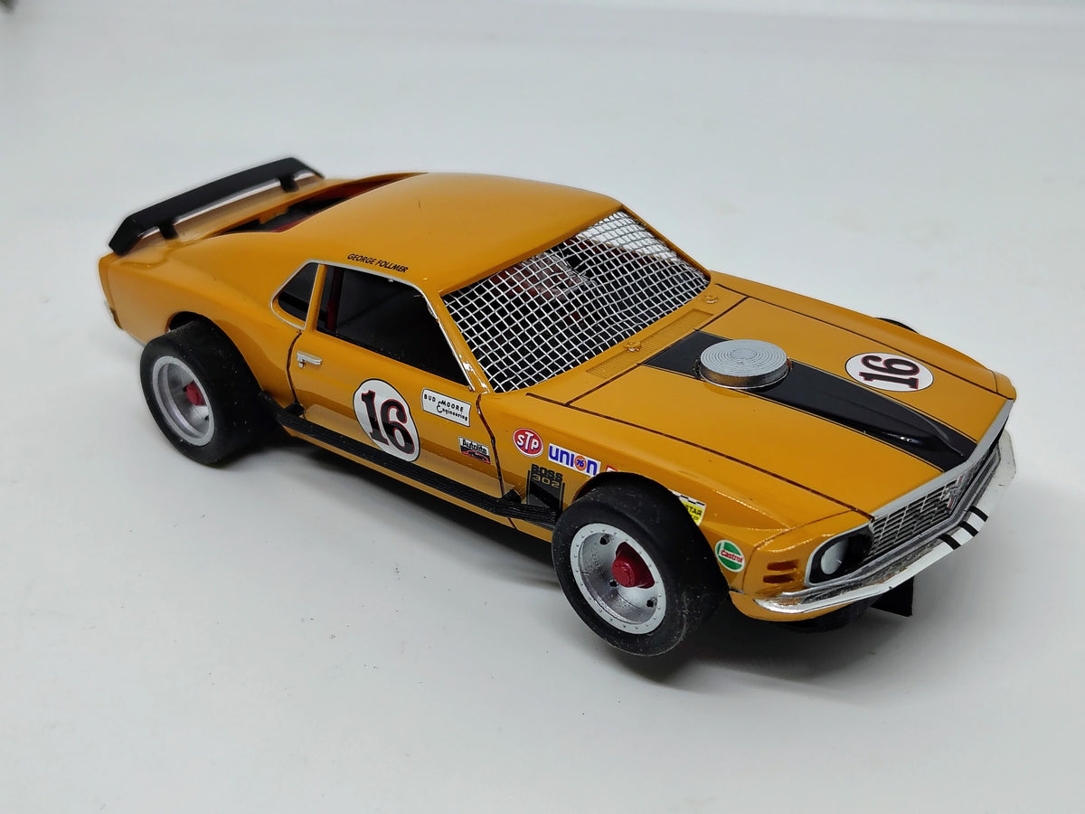 Actual SLOTRAX George Follmer #16 orange custom Mustang Boss 302 front quarter view