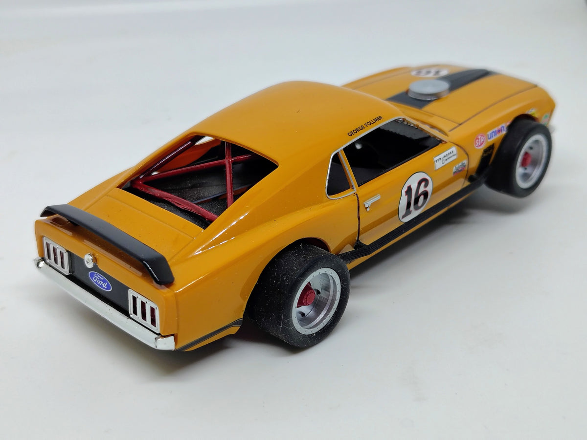 SlotTrax orange #16 Mustang rear side view with large racing tires and rear spoiler