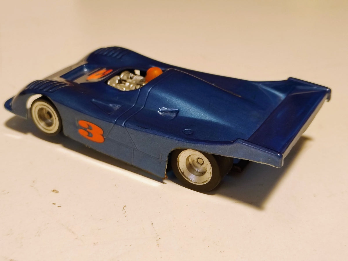 Blue number 3 vintage Can-Am racer rear quarter and rear tires
