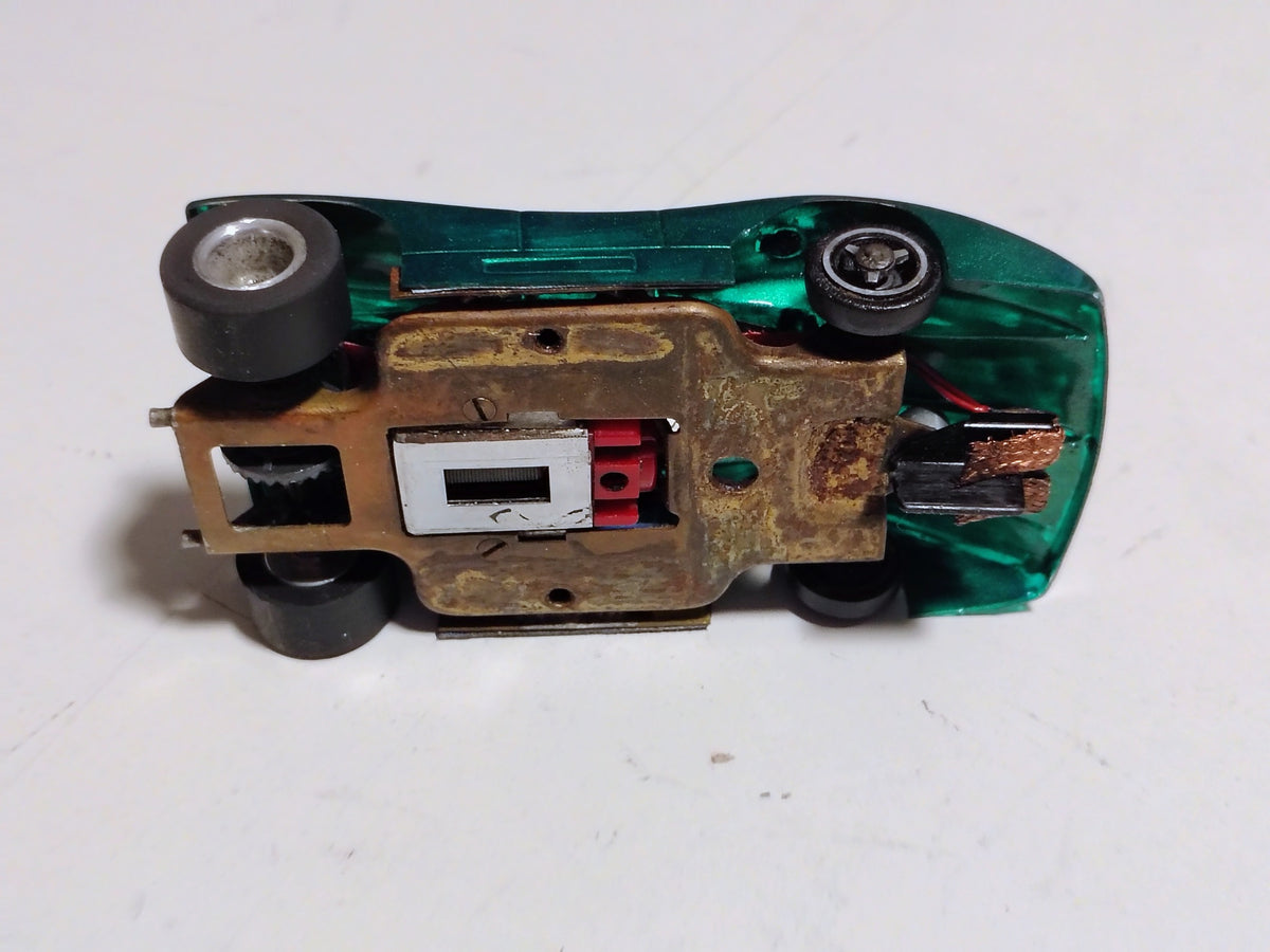 Entire underside of actual green #07 slot car brass chassis, guide and running gear